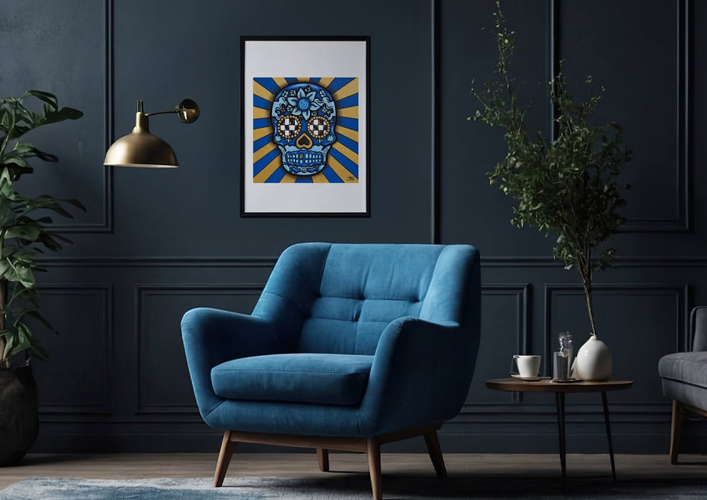 Blue Sugar Skull print framed on wall above chair.