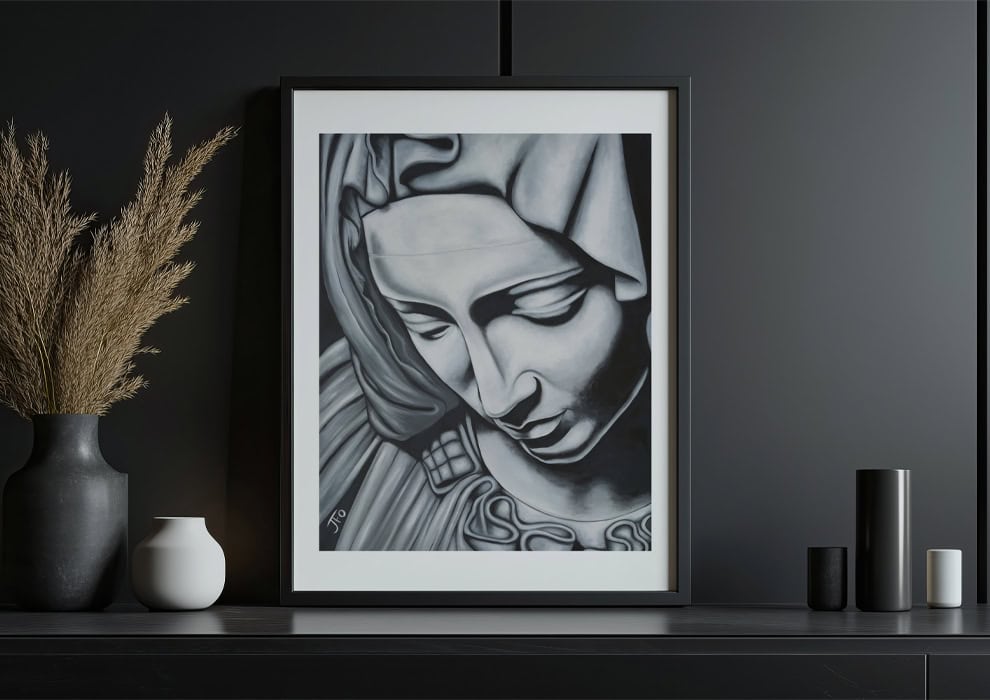 Pieta print framed and sitting on shelf.