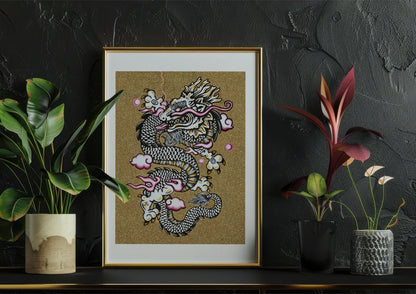 White Dragon print framed and sitting on shelf next to plants.